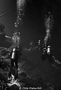 Divers exporing the Cenote by Chris Miskavitch 